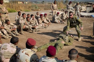 Corporal Benjamin Wallis demonstrates how to drag a casualty during a first aid lesson at the Taji Military Complex, Iraq. Photo by Corporal Oliver Carter.