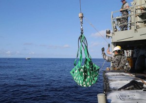 HMAS Melbourne personnel lift seized heroin aboard for processing. Photo by Able Seaman Bonny Gassner 