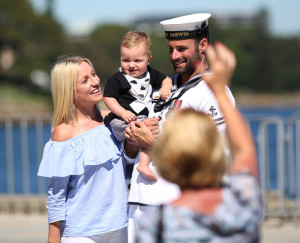 Leading Seaman Boatswains Mate Chris Bradshaw shares a moment with his partner and child before deploying to the Middle East on HMAS Darwin. Photos by Able Seaman Chantell Brown