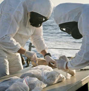 Crew members of HMAS Melbourne prepare to dispose of illegal narcotics seized from a fishing vessel in the Indian Ocean. Photos by Able Seaman Bonny Gassner