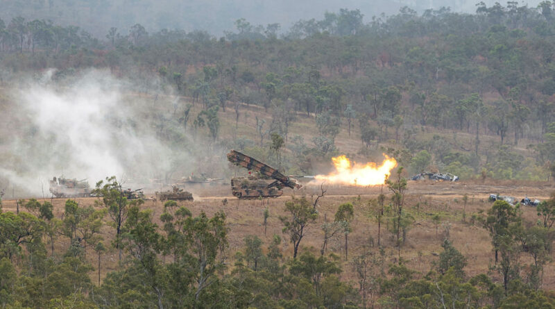 An Army M1110 joint assault bridge deploys under cover from an Abrams tank during a heavy armoured capability demonstration at the Townsville Field Training Area, Queensland. Story and photo by Warrant Officer Class 2 Max Bree.