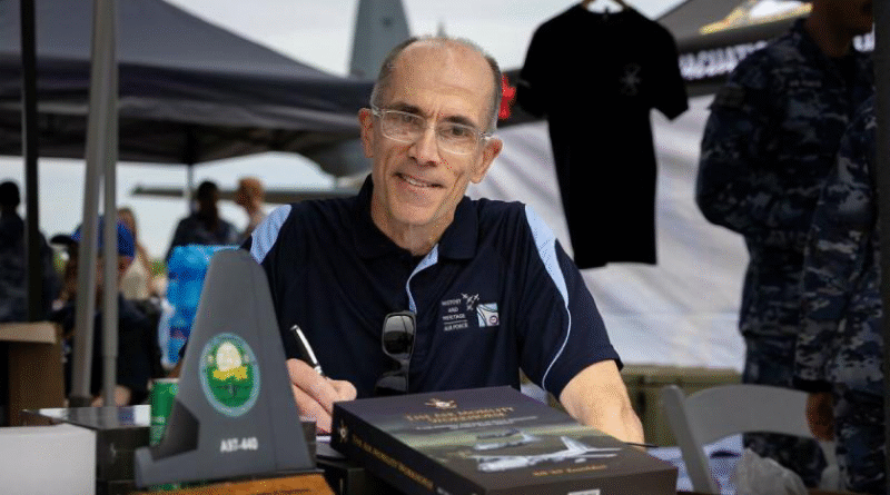 Air Commodore Bill Kourelakos (rtd) signs 'The Air Mobility Workhorse: C-130 Hercules Aircraft in Royal Australian Air Force (RAAF) Service'. Story by Squadron Leader Eamon Hamilton. Photos by Leading Aircraftwoman Aiesha White-Kratz.