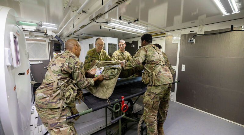 Australian Army officers from 2nd Health Brigade assist United States Army personnel in loading a Japanese Middle Army patient onto a CT machine at the Role 3 field hospital on Exercise Orient Shield 2025 at the Sekiyama Training Area, Japan. Story by Major Diana Jennings. Photos by Lance Corporal Luke Donegan.