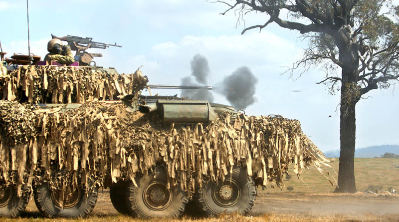 An Australian Light Armoured Vehicle fires its 25mm main gun