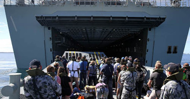 Ship's Company from NUSHIP Adelaide, play the part of civilian evacuees being transported to HMAS Canberra on a landing craft, during an evacuation exercise.