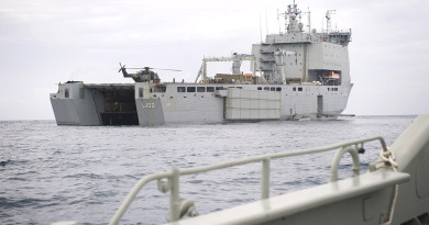 A Landing craft approaches the well dock of HMAS CHOULES during operation Render Safe 14.