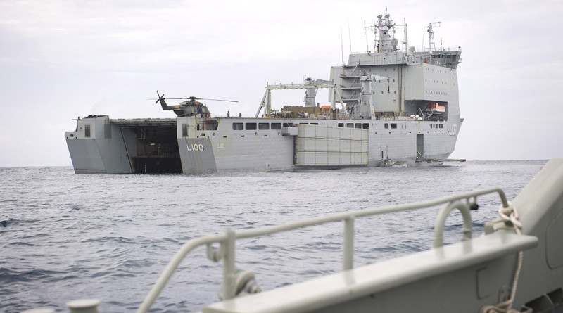 A Landing craft approaches the well dock of HMAS CHOULES during operation Render Safe 14.