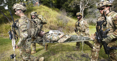 Australian Army soldiers from Force Protection Element 4 simulate evacuating a casualty during a mission rehearsal exercise.