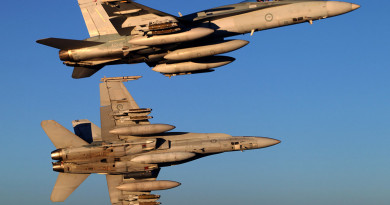 A pair of F/A-18A Hornets bank away from a KC-30A Multi Role Tanker Transport over Iraq.