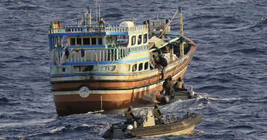 Members of HMAS Newcastle's boarding party prepare to board a dhow.