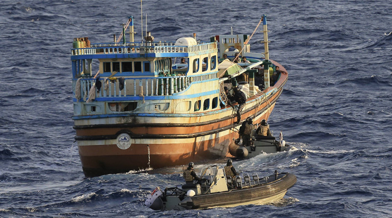 Members of HMAS Newcastle's boarding party prepare to board a dhow.