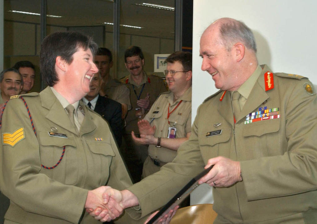 Then Chief of Army Lieutenant General Peter Cosgrove presents a 'safe driving certificate' to Sergeant Sandy McInerney.