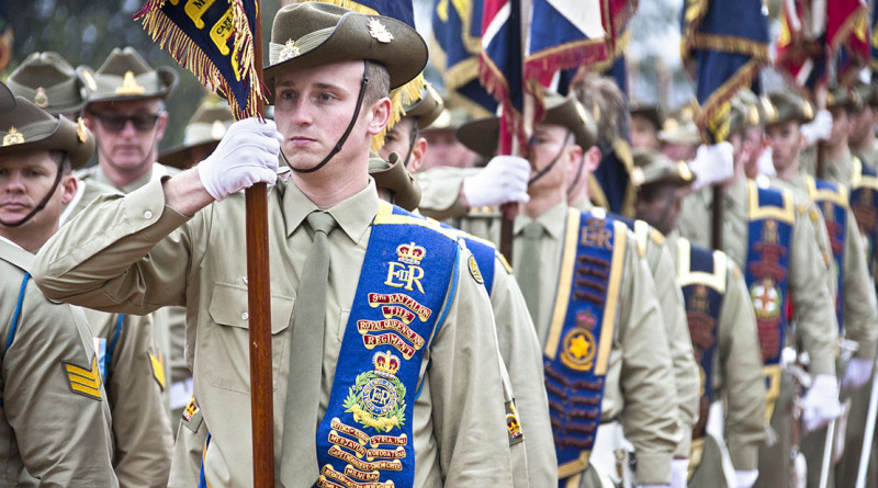 Australian Army soldiers carry 2nd Division unit colours, guidons and banners off the parade ground during the centenary parade at the Australian War Memorial, Canberra.