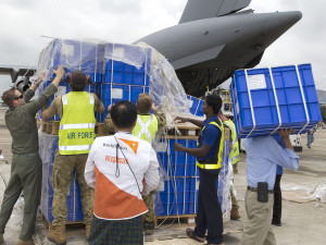 Royal Australian Air Force and World Vision staff work as a team to unload humanitarian supplies at Yangon Airport during Operation Myanmar Assist. Photo by Corporal Bill Solomou