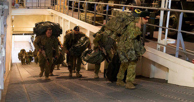 ABOVE: Soldiers from 2RAR embark HMAS Canberra as the ship prepares to sail for Exercise Sea Raider, the last exercise of Sea Series 2015. MAIN: Light Armoured Vehicles from the 2nd Cavalry Regiment drive onboard. Photos by Leading Seaman Helen Frank.