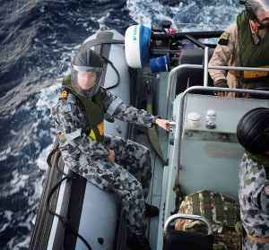 HMAS Melbourne's Medical Officer, Lieutenant Tenille Chapman waits in the seaboat while the Boarding Team embarks. They are heading to provide aid to a critically ill mariner on board the merchant vessel City of Beijing.