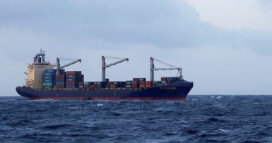 Appearing tiny against the backdrop of a freighter, crew members including the Medical Officer from HMAS Melbourne draw alongside the merchant vessel City of Beijing in Melbourne's sea boat.