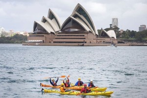 ABOVE: Australian Army and Chinese People’s Liberation Army soldiers paddle sea kayaks on Sydney Harbour during Exercise Pandaroo 2015. MAIN PHOTO: Chinese People’s Liberation Army officer Lieutenant Luo Shi Dong climbs a rock face at Point Perpendicular, NSW. Photos by Lance Corporal Kyle Genner.