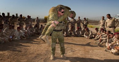 Australian Army trainer Corporal Benjamin Wallis demonstrates how to carry an injured soldier correctly on battlefield during a first aid lesson at the Taji Military Complex, Iraq. Photo by Corporal Oliver Carter.