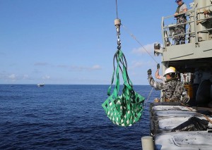 HMAS Melbourne personnel lift seized heroin aboard for processing. Photo by Able Seaman Bonny Gassner