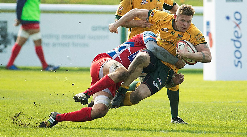 Australian Army Sergeant Scott Ashurst is tackled during the match against the French National Military rugby team at Aldershot. Photo by Corporal Janine Fabre