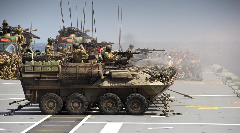 Australian Army Light Armoured Vehicles from 2nd Cavalry Regiment, conduct a live fire shoot from HMAS Canberra’s flight deck, as part of Exercise Sea Raider.