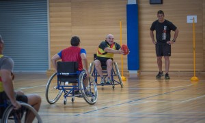 ABOVE: Major James Weaver from the ADF Australian Rules Association, takes a mark. MAIN PHOTO: Sapper Peter Hooper from the Soldier Recovery Centre - Darwin, attempts to pass the ball during a wheelchair Australian Rules workshop, held at RAAF Base Edinburgh. Photos by Corporal Nunu Campos