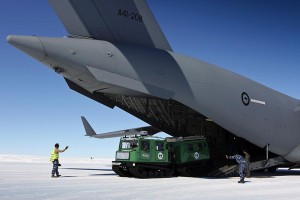 A Hägglunds snow vehicle is driven off a C-17A Globemaster at Wilkins Aerodrome, Antarctica.