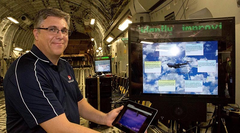 Todd Stibor, L3 Mission Integration, demonstrates wireless connectivity on a C-17A. Photo by Flight Sergeant Kev Berriman .