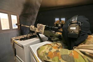 Australian Army snipers Sergeant Ben Arnold (front) and Corporal Dwain Bould prepare to shoot a target through a window.