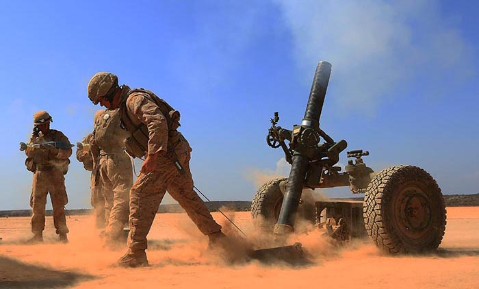 Marines with Alpha Battery, 1st Battalion 4th Marines, 13th Marine Expeditionary Unit fires a 120mm Rifled Tower Mortar. USMC photo by SSgt Matt Orr