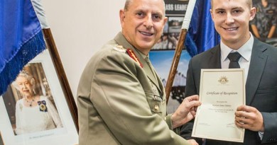 Recruit Harrison Delaney receives his Certificate of Recognition from Major General David Coghlan.