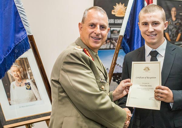 Recruit Harrison Delaney receives his Certificate of Recognition from Major General David Coghlan.