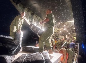Aid supplies are unloaded by Fijian soldiers from an RNZAF C-130 Hercules in Suva, Fiji. NZDF photo