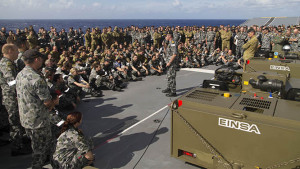 Commander Amphibious Task Group Captain Brett Sonter addresses ship's company and embarked forces on the flight deck of HMAS Canberra. All photos by Leading Seaman Helen Frank