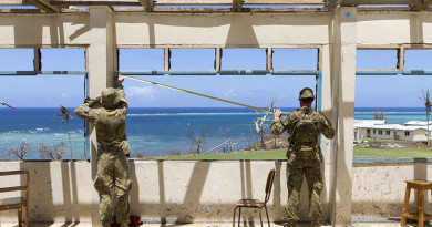 Australian Army Sappers John Corn and Ty Fergus from the 2nd Combat Engineer Regiment, assess a damaged school in the village of Nasau on Koro Island as a part of Operation Fiji Assist.