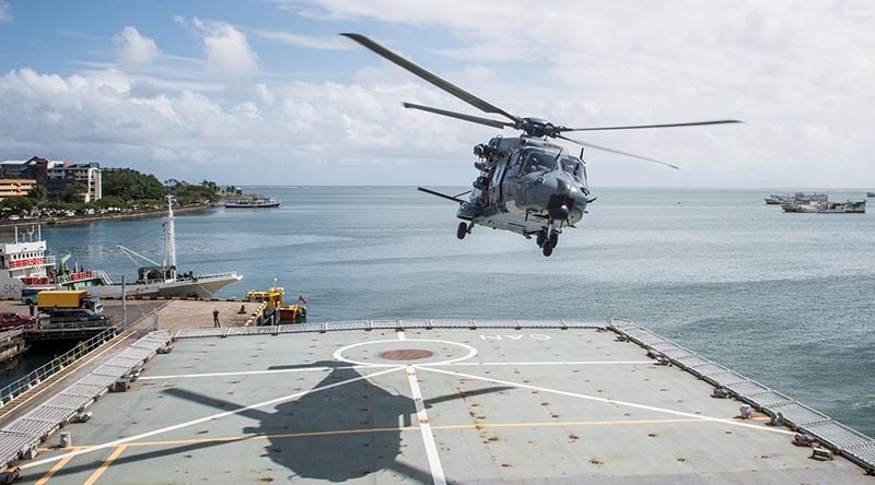 A RNZAF NH90 Helicopter takes off from the flight deck of HMNZS Canterbury whilst along side in Suva Port. The NZDF has deployed to Fiji to provide Humanitarian Aid and Distaster Relief following Tropical Cyclone Winston. NZDF photo