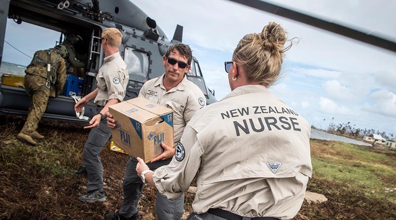 A RNZAF NH90 Helicopter lands in Nasau, Koro Island to deliver personnel, aid, and equipment. The NZDF has deployed to Fiji to provide Humanitarian Aid and Distaster Relief following Tropical Cyclone Winston. Members of the New Zeland Medical Assistance Team help unload.