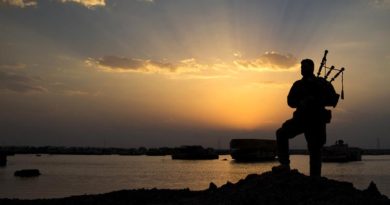 Australian soldier Corporal Kenneth Horton, of Task Group Taji, plays the bagpipes as the sun sets over the Taji Military Complex, Iraq. Photo by corporal Jake Sims