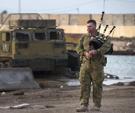 Australian soldier Corporal Kenneth Horton plays his bagpipes at the Taji Military Complex, Iraq. Photo by Corporal Jake Sims