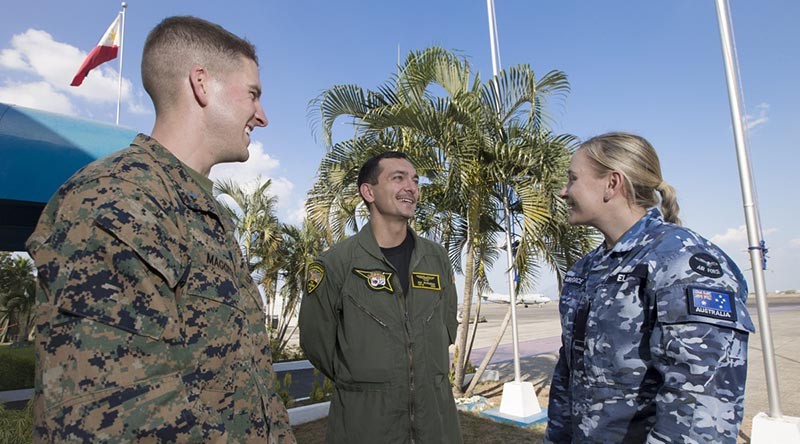 First Lieutenant Michael Maggitti of the United States Marine Corps (left) and Lieutenant Commander Ian Burgess of the United States Navy chat with Flying Officer Danica Ellis of 92 Wing during Exercise Balikatan 2016. Photo by Corporal David Said