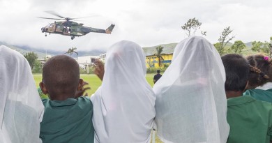 Students from the Rakiraki Muslim Primary School cheer as an Australian Army Taipan MRH-90 helicopter takes off for another mission during Operation Fiji Assist. Photo by Corporal Dan Pinhorn