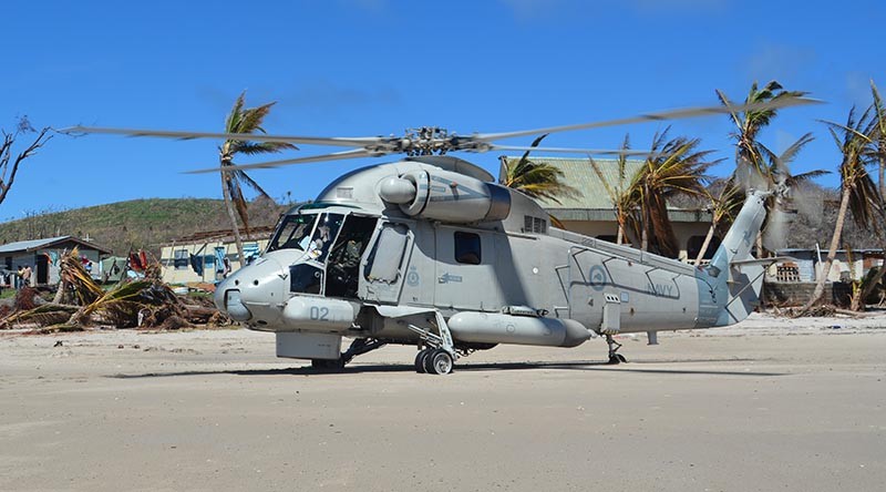 An SH-2G(NZ) Seasprite helicopters assisting with cyclone-recovery operations in Fiji.