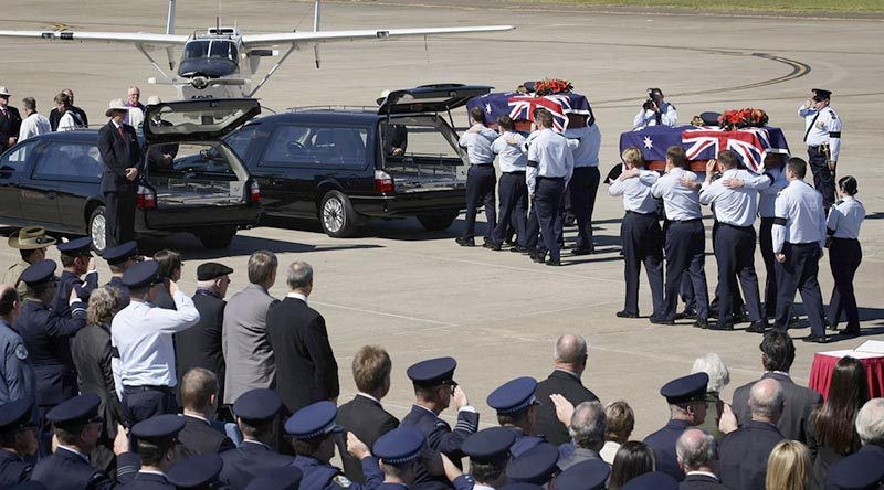 Onlookers pay respects as two caskets are carried to waiting hearses during the repatriation of two Australian servicemen missing from the Vietnam War. Flying Officer Michael Herbert and Pilot Officer Robert Carver failed to return from a routine bombing mission on 3 November 1970. They were recovered in thick jungle in an rugged, remote and sparsely populated area of Quang Nam Province, Vietnam, near the Laotian border, and repatriated to Australia in 2009. Photo by Leading Aircraftwoman Amanda Campbell.