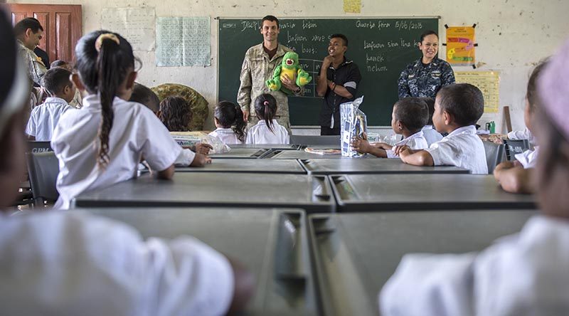 GLENO, Timor Leste (June 15, 2016) Cpl. Anatoliy Derepa, a member of the New Zealand Defense Force, and a native of Wellington, New Zealand, assigned to USNS Mercy (T-AH 19), educates local Timorese children at the Dona Ana Lemos Escuela elementary school on basic oral hygiene during a Pacific Partnership 2016 health outreach event. (U.S. Navy photo by Mass Communication Specialist 2nd Class William Cousins/Released)