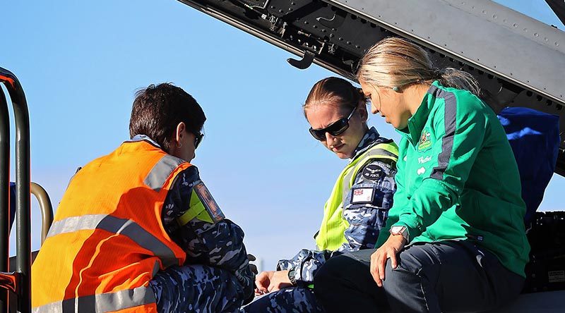 Leading Aircraftwoman Vanessa McNeil (left) and Leading Aircraftwoman Annie Tulloch show Katrina Gorry the cockpit of an F/A-18F Super Hornet during her visit to RAAF Base Amberley.