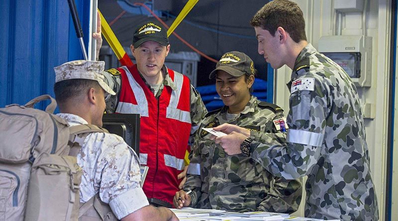 U.S. Marines receive a welcome aboard booklet upon arrival to the HMAS Adelaide at Port of Brisbane, Queensland, Australia, June 16, 2016. This marks the first time Marines and sailors from Marine Rotational Force - Darwin have embarked in such numbers on an Australian HMAS. This opportunity allows for MRF-D to expand the partnership capabilities with our Australian allies. The Marines are with 1st Battalion, 1st Marine Regiment, MRF-D, and the Australians are with HMAS Adelaide. (U. S. Marine Corps Photo by MCIPAC Combat Camera Lance Cpl. Osvaldo L. Ortega III/Released)