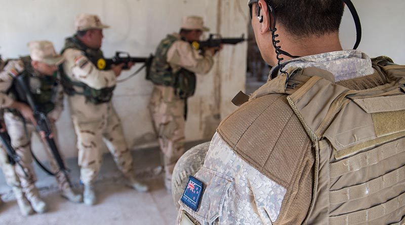 A New Zealand member of Task Group Taji, Training Task Unit supervises urban combat training for members of Iraq's 92nd Brigade at Taji Military Camp.