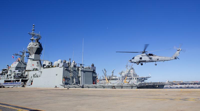 HMAS Perth receives her MH-60R 'Romeo' helicopter before departure on operation Manitou.