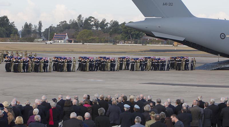 Australian Defence Force personnel from Australia’s Federation Guard carry the coffins of the 33 Australian service personnel and dependants from a Royal Australian Air Force C-17A Globemaster aircraft during the repatriation ceremony at RAAF Base Richmond in Sydney on Thursday, 02 June 2016.